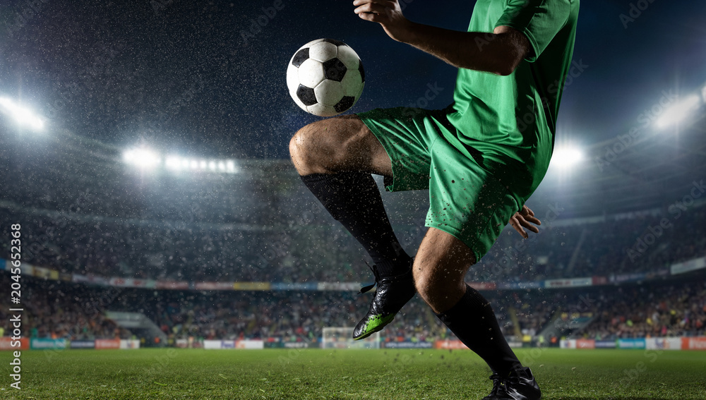 Naklejka premium Soccer player knee juggling ball under stadium floodlights. Concept of technical skill, freestyle training, sportswear campaign, match media, and athlete performance.