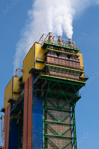 Industrial Power Plant with Steam Emissions and Blue Sky