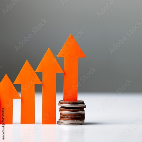 Growth in Real Estate Investment With Orange Houses and Coins on White Table