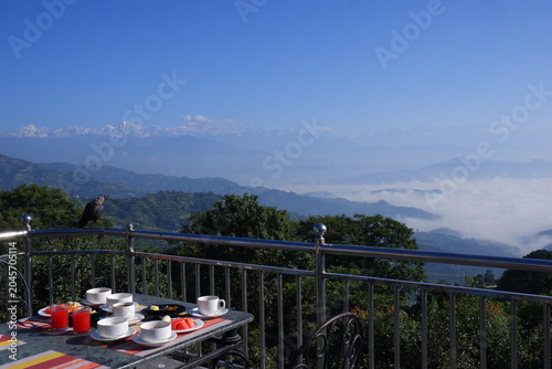 Fotografie Breakfast served on the outdoor table with the background of Himalayan mountain