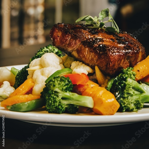 Delicious Grilled Steak Served With Mixed Vegetables on a White Plate