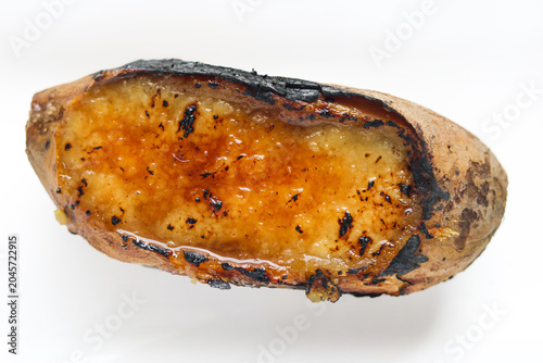 Obraz na plátně A single roasted sweet potato cut open and topped with caramelized, and torched sugar layer (Crème Brûlée)