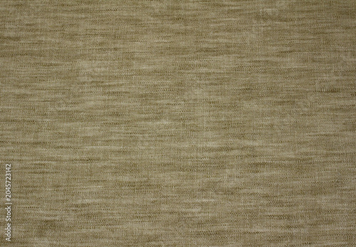 Texture of beige linen like fabric background. Close up of seamless light brown polyester cloth.