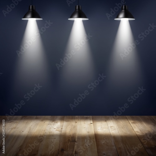 Three Lights Shine Down on a Wooden Floor in an Empty Room at Night