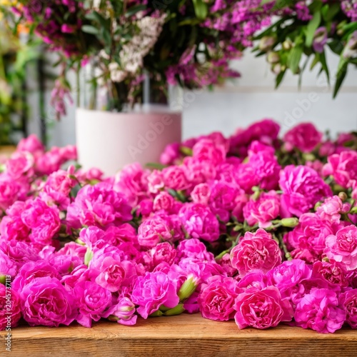 Flowers Are Arranged on a Wooden Table in a Shop During the Daytime