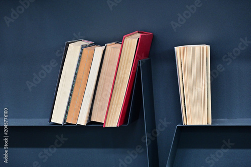 creative composition of books arrranged on shelves