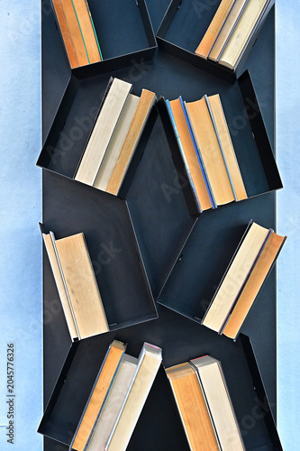creative composition of books arrranged on shelves