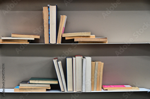 creative composition of books arrranged on shelves
