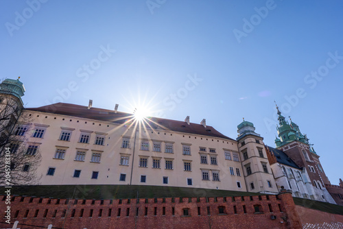 Sun shines bright over Wawel Castle in Krakow during clear day