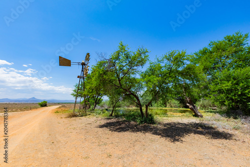 Windmill wind pump borehole in arid landscape