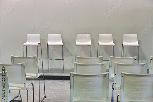 empty white audience seats before convention event