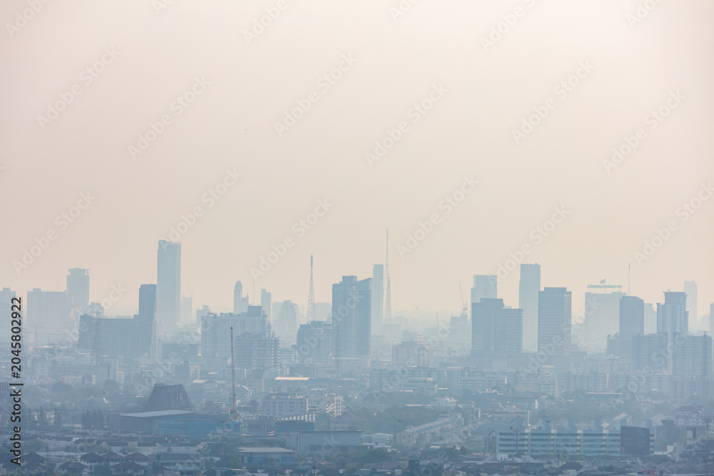 Fototapeta premium Dense modern city metropolis obscured by heavy fog and thick dangerous air pollution.