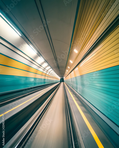 First person perspective motion blur in futuristic underground metro tunnel with neon lighting