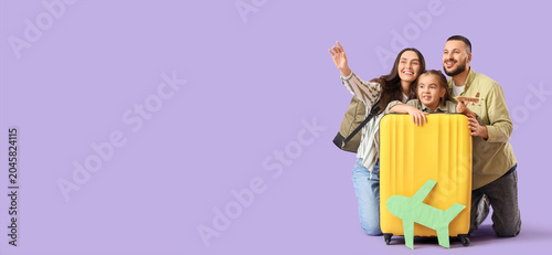 Family of travelers with su...
