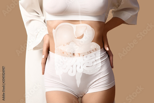 Fotografija Beautiful young woman in white underwear on brown background, closeup