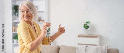 Mature woman dancing at home