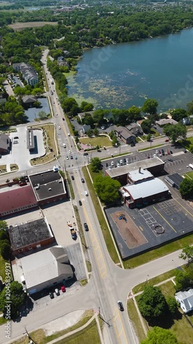 Vertical Drone Video of a Bustling Intersection in a Picturesque Lakeside Town