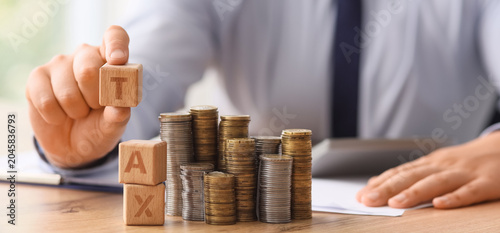 Businessman with word TAX a...