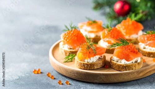 Festive Smoked Salmon and Caviar Canap?s on a Wooden Board with Christmas Decorations.