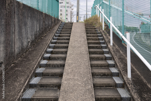 Foto Concrete staircase with bicycle ramp between steps in urban area