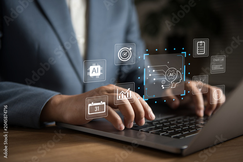 Business professional using laptop with artificial intelligence interface, workflow automation, data analytics, productivity management and digital transformation technology for smart business.