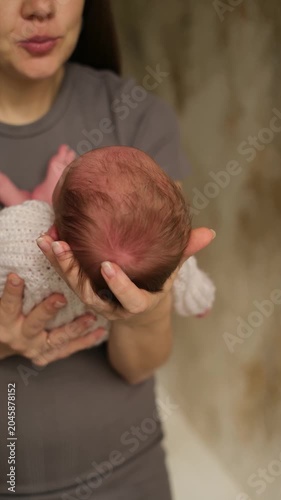 mother and newborn baby, mother and child, baby sleeping in mom's arms, mother gently embracing and kissing her little child, motherhood, young family