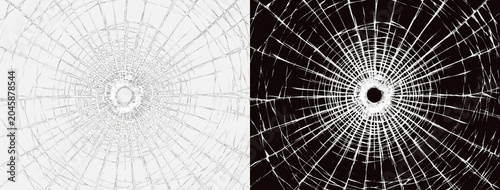 Photos Shattered broken glass with central bullet hole impact and radial cracks isolate