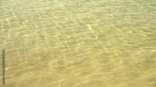 Crystal Clear Water on Sandy Shore, Sunlight Reflections