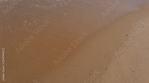 Sea waves rolling onto a sandy beach, the concept of rest and relaxation