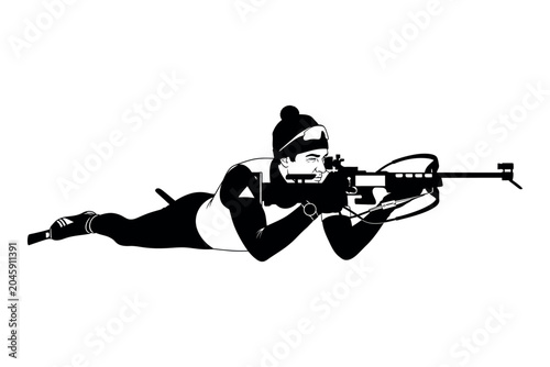 Foto Biathlon silhouette a female athlete in prone position aiming with a rifle winte
