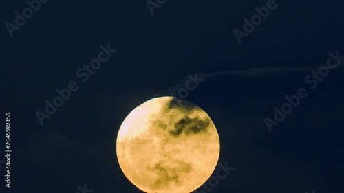 A bright full moon glowing in the dark night sky, captured during its ascent over Shimen, New Taipei City, Taiwan.