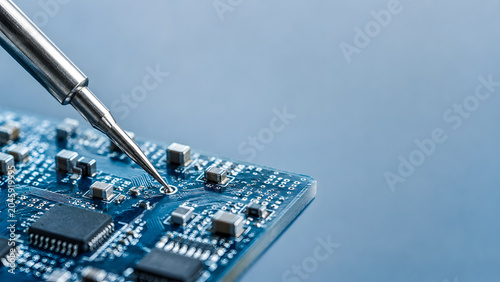 Soldering Iron Repairing Blue Circuit Board Macro