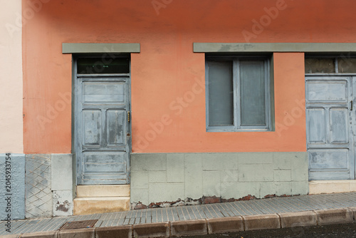 Peach house with gray window frame