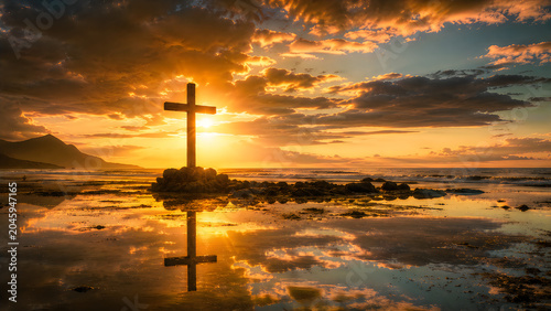 Cross silhouette at sunrise over calm reflective water with dramatic sky