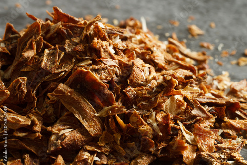 Dried onion flakes detail showing natural texture and appearance of a culinary herb used for seasoning and cooking.