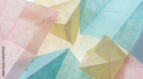 Translucent pastel colored paper folded into geometric shapes. Soft light illuminates the delicate texture. Abstract background for design.