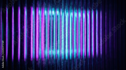 Corrugated metallic surface reflecting vibrant neon purple and blue lights. Abstract background with vertical stripes.