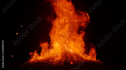 Massive Intense Fire Explosion With Fiery Debris Ascending Against Dark Black Background with Orange Glow and Sparks