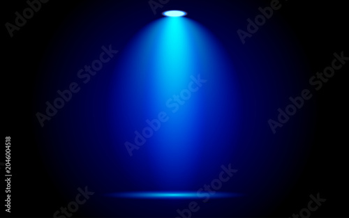 A single bright blue spotlight shining down on a dark stage or background.