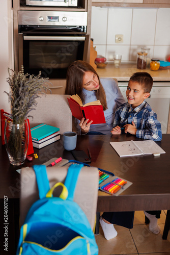 Mother helping son study for school