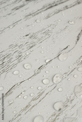 Water droplets on an interior film with a whitewashed wood print