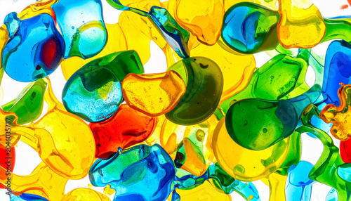 Abstract macro shot of colorful plastic fragments melting and fusing together on a white background