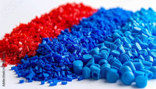 Neatly organized rows of multi colored recycled plastic fragments raw polymer pellets and flakes sorted on a bright surface