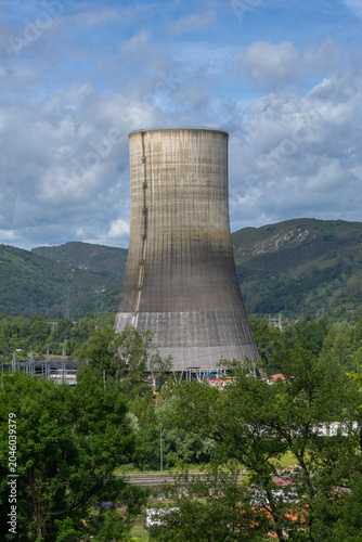 Huge industrial cooling tower in a mountain landscape. Power plant