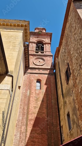 Low-angle view of the bell tower of the Santa Maria Maddalena church ringing its bells
