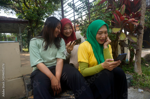 Happy Group Of Asian Females Looking Their Favourites Football Team Match On Live Streaming