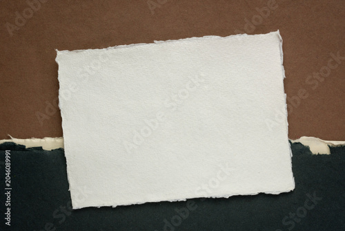 фотографія small blank sheet of watercolor paper against abstract art paper landscape