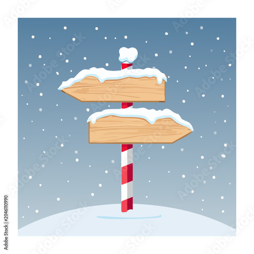 Wooden signpost covered in snow during winter snowfall