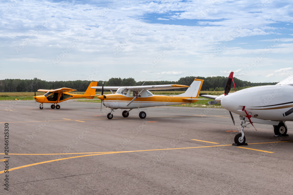 Fototapeta premium Small private aircrafts parked at the airfield