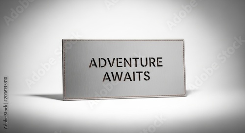 Inspirational motivational sign, Adventure Awaits text, gray metal plate